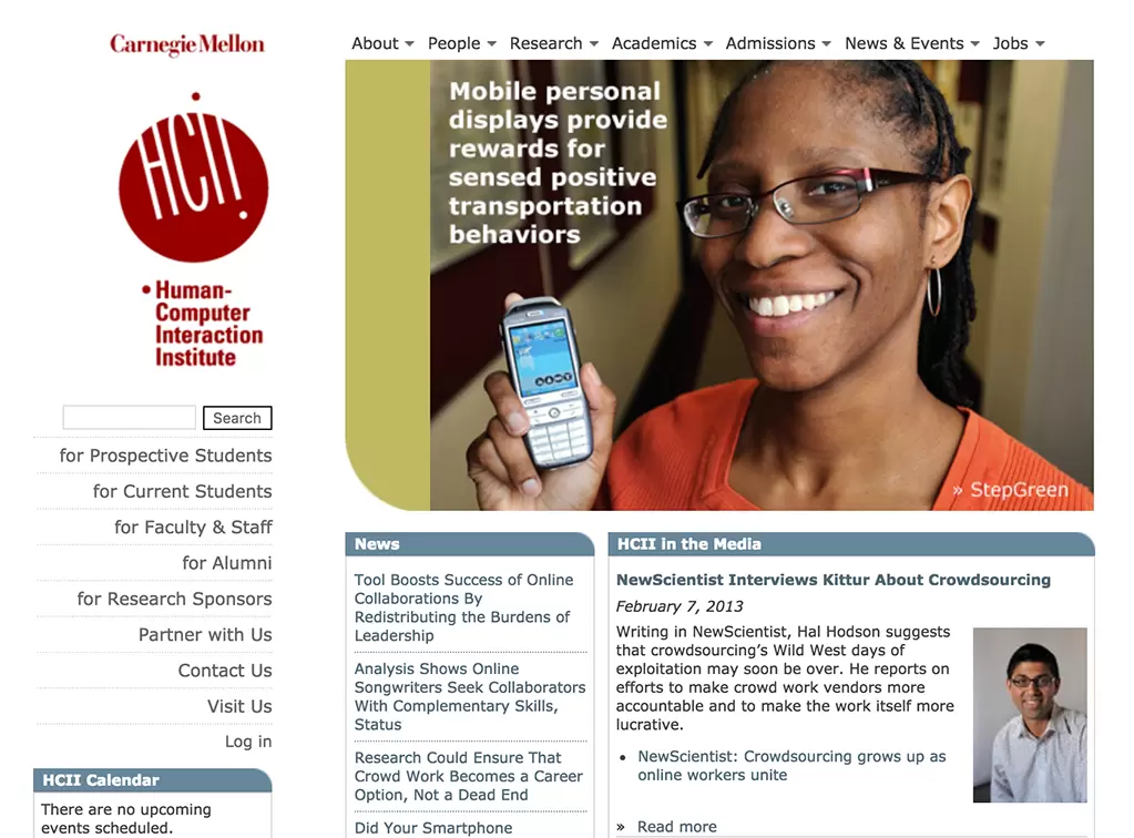A person smiling while holding a mobile device on what appears to be an NCRM website.