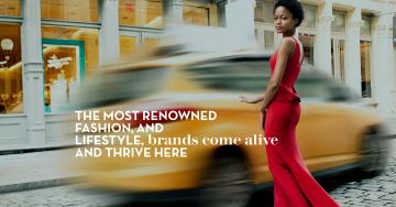 A person in a flowing red gown walking on a street with blurred motion in the background.