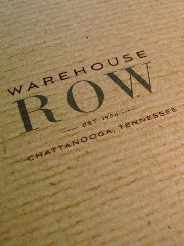 Warehouse Row logo on textured tan paper from Chattanooga, Tennessee.