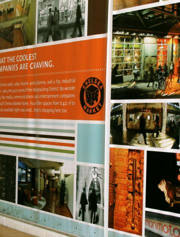 A display wall featuring historical photos and information about a business with orange highlights and text panels.