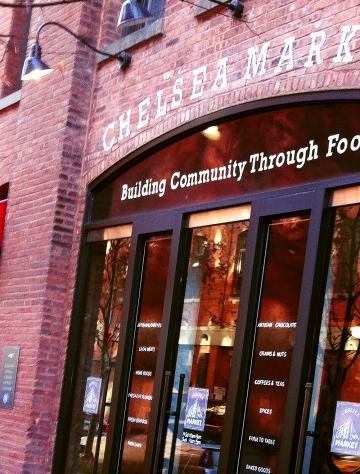Brick storefront of a chemistry-themed business with illuminated sign