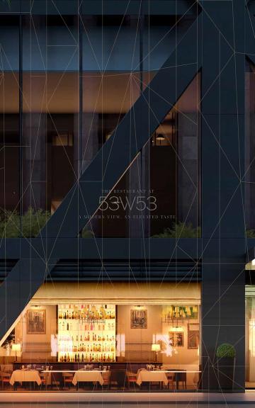 Night view of a multi-story building with illuminated interior spaces visible through glass walls.